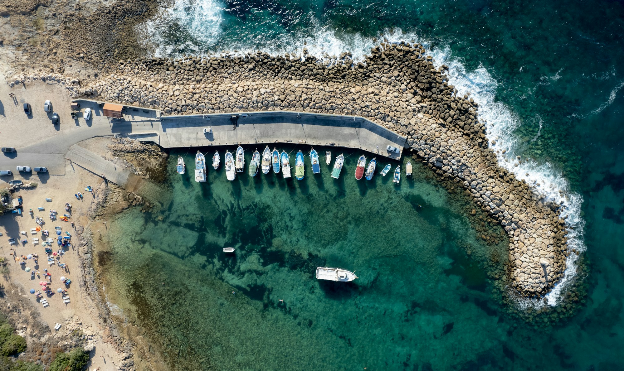 Aerial drone view of fishing boats moored at the harbor. moored at breakwater