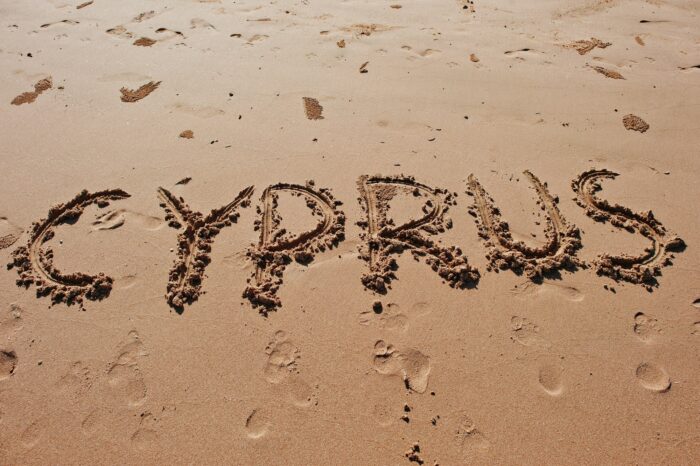 "Cyprus" written in the sand on the beach